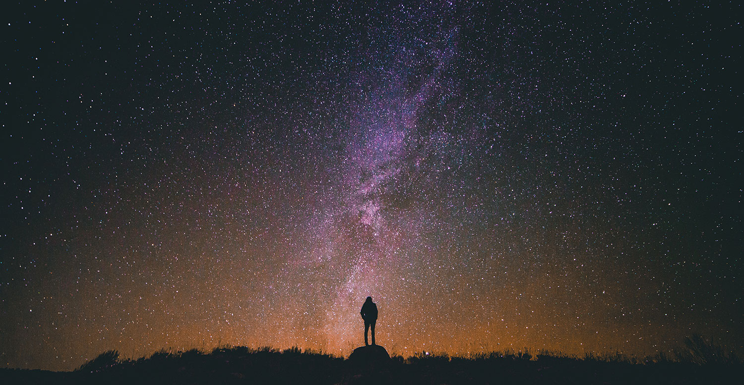 Photo of a person silhouetted against the night sky